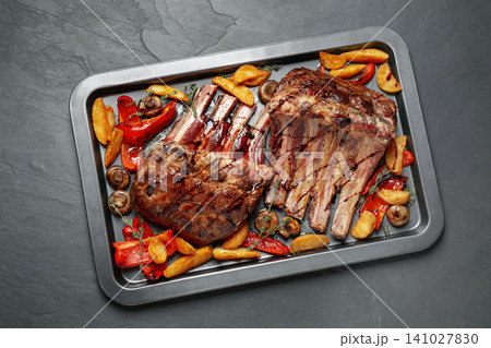 Delicious roasted ribs with garnish, top view Delicious roasted ribs with garnish, top view 141027830