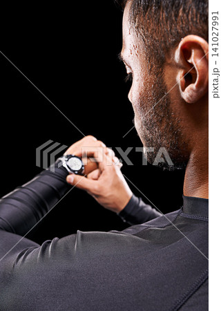 Athlete, man and check watch with fitness for performance monitor, training progress and exercise time with rear view. Person, clock and running challenge for wellness in studio on black background Athlete, man and check watch with fitness for performance monitor, training progress and exercise time with rear view. Person, clock and running challenge for wellness in studio on black background 141027991