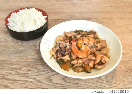 spicy fried shrimp and squid with mussel chili basil on plate eat with plain rice 141028019