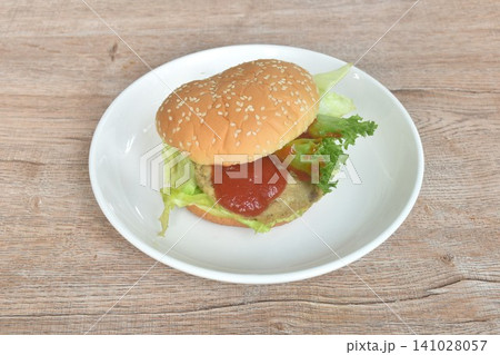 fried mashed beef hamburger stuffed fresh vegetable with ketchup on plate fried mashed beef hamburger stuffed fresh vegetable with ketchup on plate 141028057