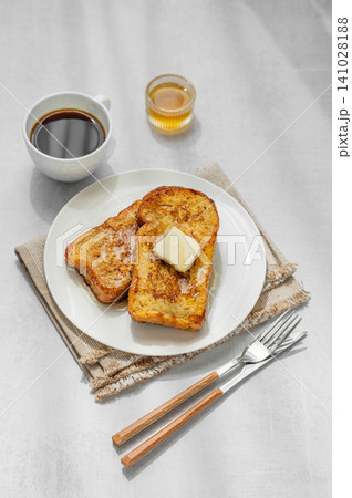 Brioche toasts with butter and honey on a plate on a concrete background 141028188