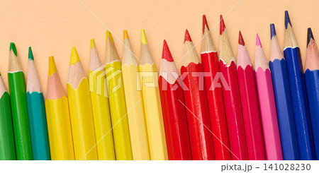 Multicolored wooden pencils in a row, drawing and creativity tools Multicolored wooden pencils in a row, drawing and creativity tools 141028230