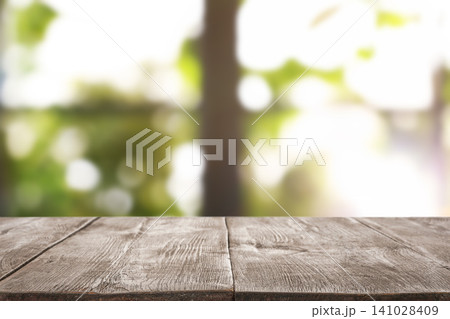 Empty wooden table in front of window. Sunny morning 141028409