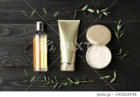Flat lay composition with cosmetic products on black wooden table Flat lay composition with cosmetic products on black wooden table 141028548