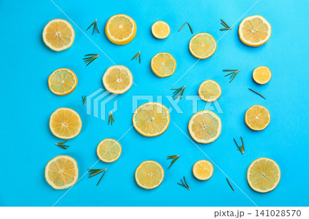 Lemonade layout with juicy lemon slices and rosemary on blue background, top view 141028570
