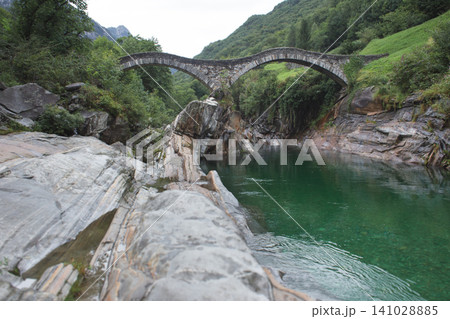 Ponte dei Salti double arch stone bridge over turquoise Verzasca river in Switzerland Ponte dei Salti double arch stone bridge over turquoise Verzasca river in Switzerland 141028885