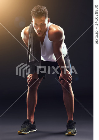 Fitness, relax and man in studio with breathing, sweat and exhausted commitment to muscle workout. Air, rest and tired athlete on black background for exercise, towel and fatigue in morning training. 141028930
