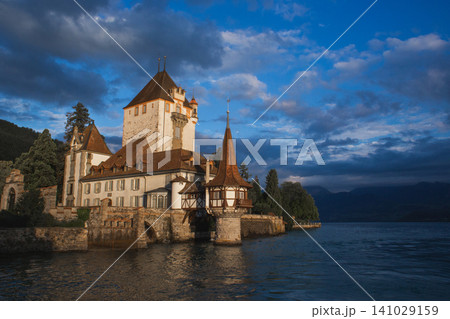 Majestic Oberhofen Castle on the shores of Lake Thun at sunset in Switzerland 141029159