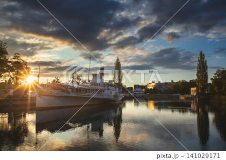 Historic paddle steamer at sunset in Interlaken harbor Switzerland Historic paddle steamer at sunset in Interlaken harbor Switzerland 141029171
