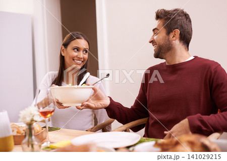 Smile, dinner and couple at table with salad, food, and drinks for celebration in home. Social event, man and woman at thanksgiving lunch together with wine, relax and romantic holiday date in house 141029215