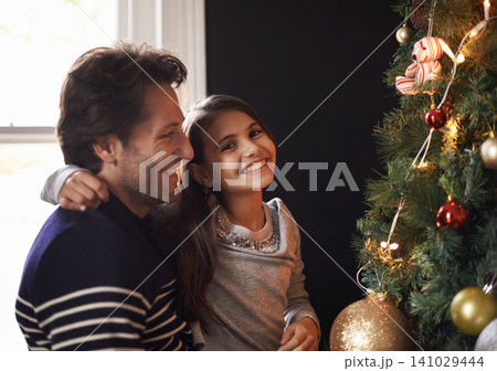 Portrait, child and dad at tree for Christmas decoration, bonding and fun in family home. Festive, xmas decor and father with girl kid, smile and happy holiday together in care, love and celebration. Portrait, child and dad at tree for Christmas decoration, bonding and fun in family home. Festive, xmas decor and father with girl kid, smile and happy holiday together in care, love and celebration. 141029444