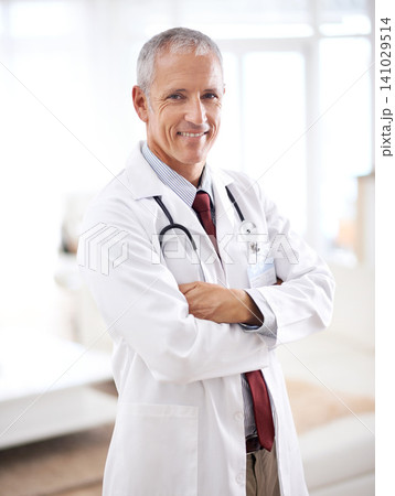 Portrait, medicine and doctor man with arms crossed in hospital for support, services and wellness. Healthcare, lens flare and happy mature medical professional for confident, smile and treatment Portrait, medicine and doctor man with arms crossed in hospital for support, services and wellness. Healthcare, lens flare and happy mature medical professional for confident, smile and treatment 141029514