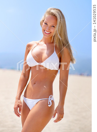 Summer, beach and portrait of woman in bikini on vacation, adventure or holiday for travel. Smile, excited and young female person in swimwear on tropical weekend trip by ocean or sea in Australia. 141029535