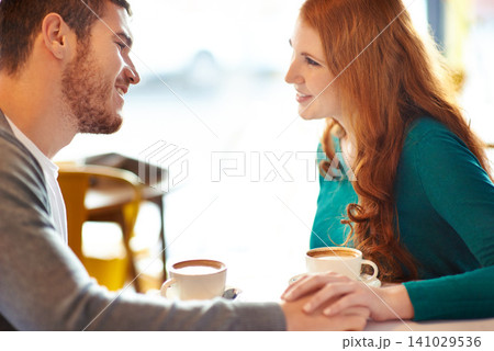 Couple, happy and smile in cafe for coffee, conversation or discussion on date with love. Support, comfortable together and trust in relationship bonding, people at table with cappuccino in mug Couple, happy and smile in cafe for coffee, conversation or discussion on date with love. Support, comfortable together and trust in relationship bonding, people at table with cappuccino in mug 141029536