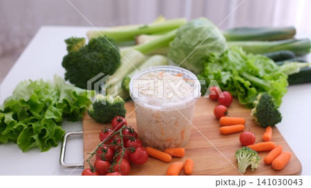 Fork with healthy sauerkraut beside fresh vegetables on rustic wooden table Fork with healthy sauerkraut beside fresh vegetables on rustic wooden table 141030043