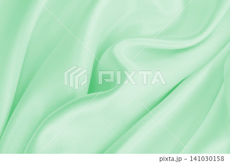 Smooth elegant green silk or satin luxury cloth texture as abstract background. Luxurious background design Smooth elegant green silk or satin luxury cloth texture as abstract background. Luxurious background design 141030158