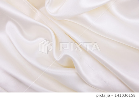 Smooth elegant white silk or satin luxury cloth texture as wedding background. Luxurious background design Smooth elegant white silk or satin luxury cloth texture as wedding background. Luxurious background design 141030159