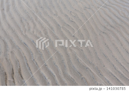 Texture of wavy sand ripple patterns formed on the beach during low tide 141030785