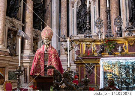 Naples, italy. December 27, 2024. Bust of san gennaro in gold, wearing an episcopal mitre and cope, inside the lavish treasure chapel of naples cathedral Naples, italy. December 27, 2024. Bust of san gennaro in gold, wearing an episcopal mitre and cope, inside the lavish treasure chapel of naples cathedral 141030878