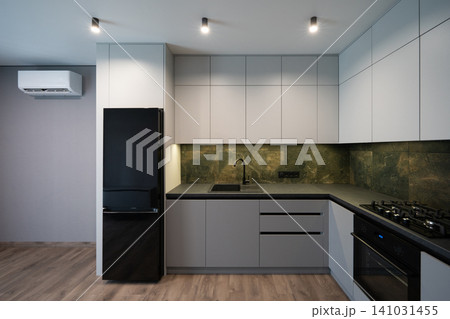 Modern minimalist kitchen with grey cabinetry and dark stone backsplash Modern minimalist kitchen with grey cabinetry and dark stone backsplash 141031455