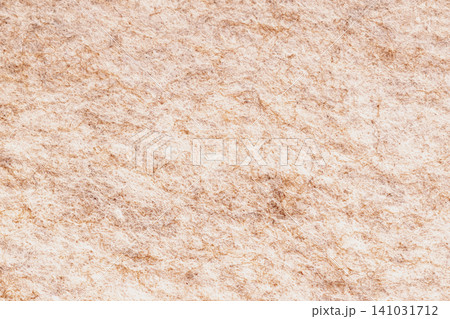Horizontal macro top view shot of a dense beige and light brown wool felt texture fabric surface with a chaotic organic fiber structure pattern detail Horizontal macro top view shot of a dense beige and light brown wool felt texture fabric surface with a chaotic organic fiber structure pattern detail 141031712