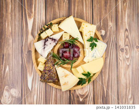 Artisanal cheese platter with grapes and fresh herbs Artisanal cheese platter with grapes and fresh herbs 141031835