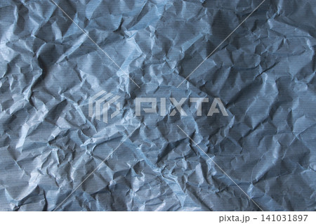 Blue crumpled paper texture with subtle horizontal stripes 141031897