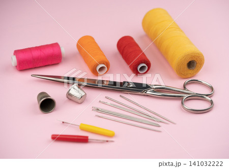 various tailor accessories and tools for tailoring on a pink background various tailor accessories and tools for tailoring on a pink background 141032222