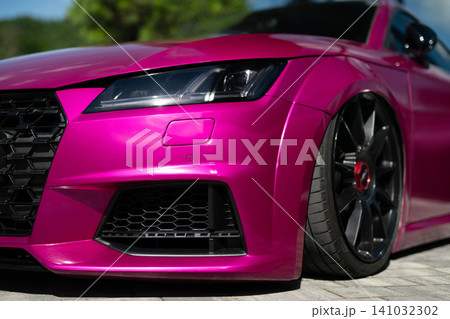 Close-up of pink modified sport car with black alloy wheels Close-up of pink modified sport car with black alloy wheels 141032302