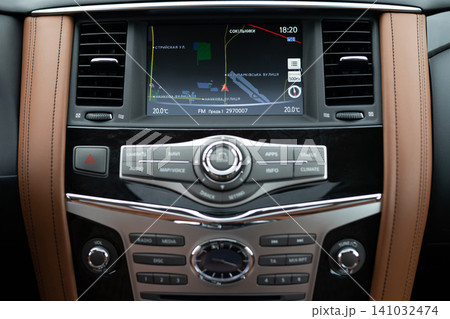 Straight interior view of a luxury SUV infotainment system and center console Straight interior view of a luxury SUV infotainment system and center console 141032474