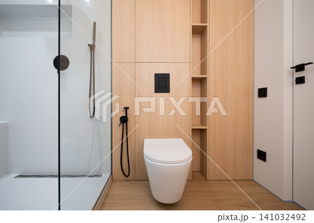 Modern minimalist bathroom with wood paneling and walk-in shower Modern minimalist bathroom with wood paneling and walk-in shower 141032492