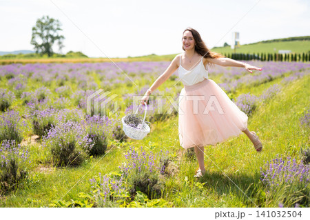beautiful girl in a dress on a lavender field with a bouquet of flowers beautiful girl in a dress on a lavender field with a bouquet of flowers 141032504