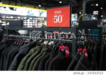 Half price clearance on winter jackets in a retail store Half price clearance on winter jackets in a retail store 141032522