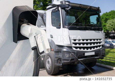 Electric vehicles charging station on a background of a truck. Electric vehicles charging station on a background of a truck. 141032735