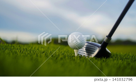 Golf clubs and balls on a green lawn in a beautiful golf course with morning sunshine. 141032796