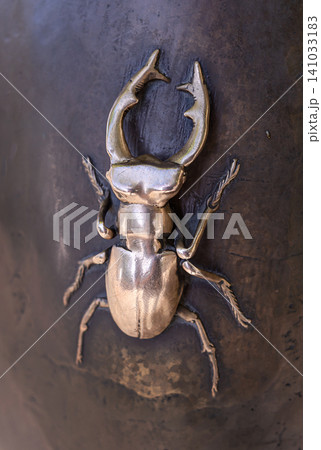 KYIV, UKRAINE - SEPTEMBER 24, 2024: Bronze stag beetle close up as a fragment of the monument "Chasing Two Hares" on Andreevsky Descent in Kyiv KYIV, UKRAINE - SEPTEMBER 24, 2024: Bronze stag beetle close up as a fragment of the monument "Chasing Two Hares" on Andreevsky Descent in Kyiv 141033183