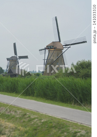 Historic windmills of Kinderdijk along a canal in the Netherlands 141033310