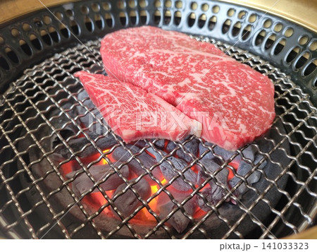 Premium Korean Hanwoo Ribeye Steak Grilling on Charcoal Brazier Wire Net 141033323