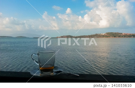 a mug of tea on a saucer on a seascape 141033610