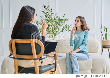 Social worker listening to teenage girl in the office Social worker listening to teenage girl in the office 141034112
