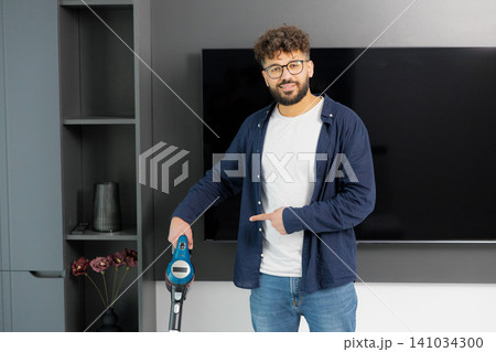 Man showing approval for effective home cleaning Man showing approval for effective home cleaning 141034300