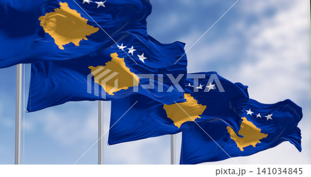 Kosovo national flags waving on a clear day Kosovo national flags waving on a clear day 141034845