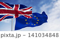 Flags of United Kingdom and the European Union waving in the wind 141034848