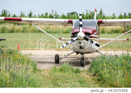 Corby, United Kingdom – July 1, 2026: Light aircraft parked beside hangar at a small airfield, editorial Corby, United Kingdom – July 1, 2026: Light aircraft parked beside hangar at a small airfield, editorial 141035408