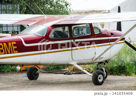 Corby, United Kingdom – July 1, 2026: Light aircraft parked beside hangar at a small airfield, editorial Corby, United Kingdom – July 1, 2026: Light aircraft parked beside hangar at a small airfield, editorial 141035409