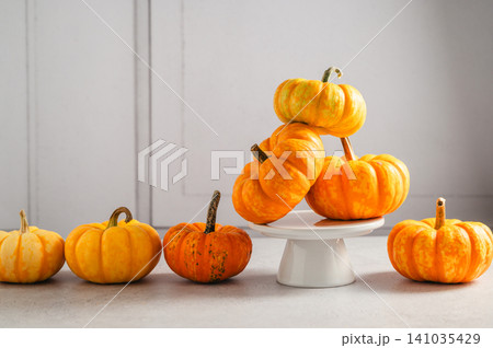 Ornamental pumpkins on cake stand with copy space, autumn still life 141035429
