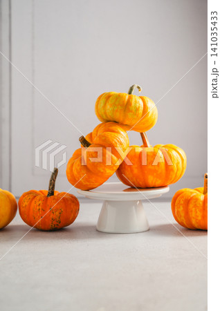 Ornamental pumpkins on cake stand with copy space, autumn still life Ornamental pumpkins on cake stand with copy space, autumn still life 141035433