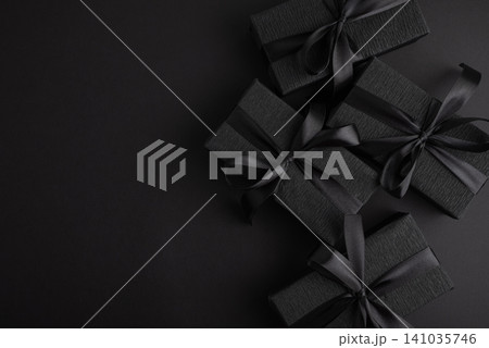 Black gift boxes with elegant silk ribbons Black gift boxes with elegant silk ribbons 141035746