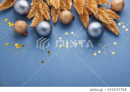 Christmas holiday background with golden branches and blue ornaments 141035768