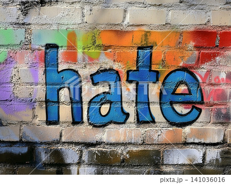 Graffiti art on a brick wall with the word 'hate' in colorful spray paint design 141036016